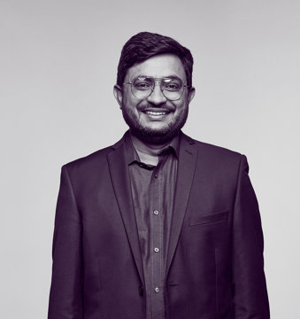 Dr Sabar, an oncologist, wearing a suit and smiling at the camera