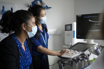 Trainee and consultant radiologists, conducting an ultrasound consultation 