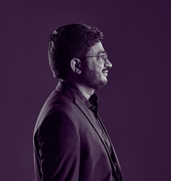 Dr Sabar, an oncologist, wearing a suit, standing in profile for the camera